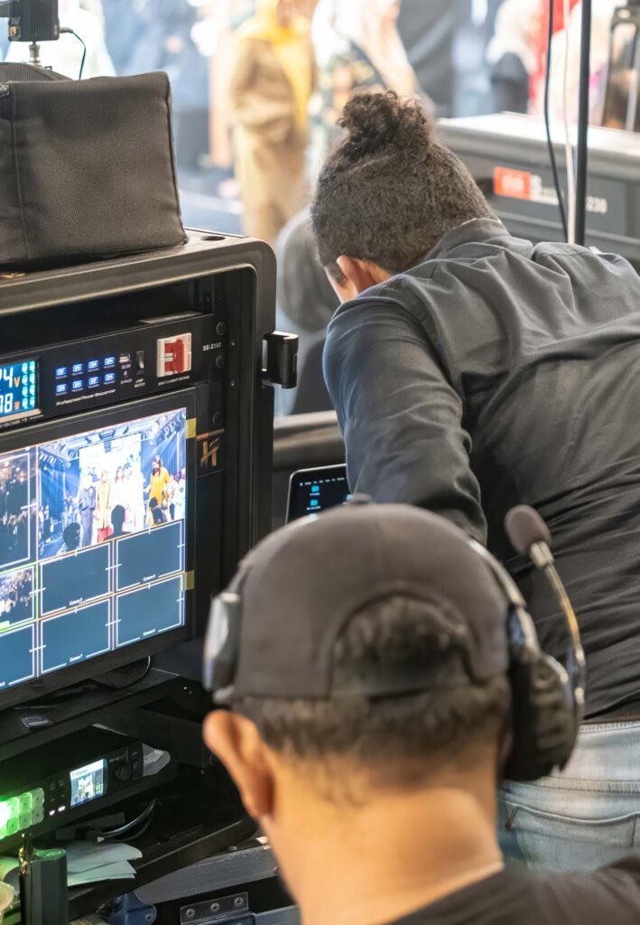 AV technicians monitoring live video feeds and audio during a professionally managed event or broadcast
